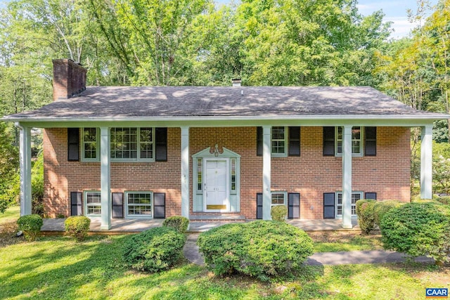 411 Westmoreland Ct, Charlottesville, VA 22901 - bi-level home with a chimney, brick siding, a shingled roof, and a porch