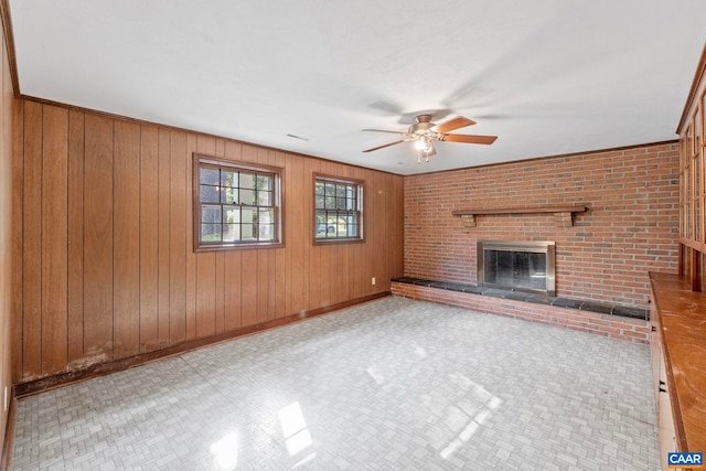 411 Westmoreland Ct, Charlottesville, VA 22901 - unfurnished living room featuring ceiling fan, a brick fireplace, and wood walls
