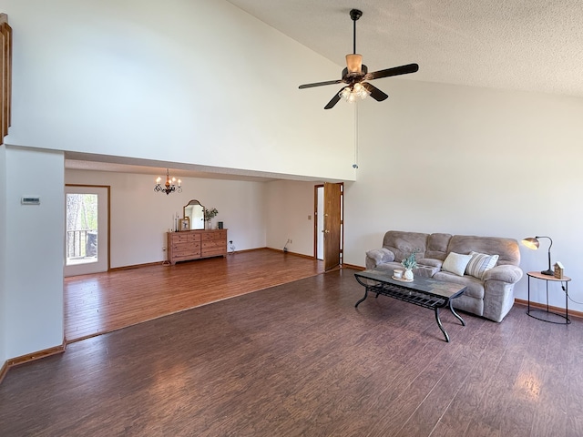 living room with high vaulted ceiling, wood finished floors, a chandelier, baseboards, and ceiling fan