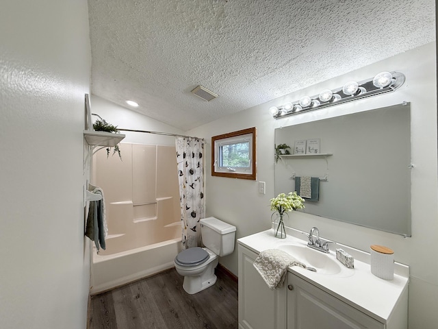 full bath featuring wood finished floors, toilet, a textured ceiling, vanity, and vaulted ceiling