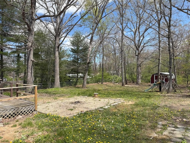 view of yard with a deck and fence