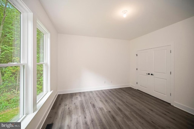  - unfurnished bedroom featuring wood finished floors and a closet