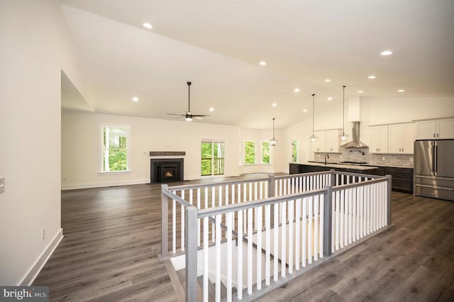  - hall featuring an upstairs landing, healthy amount of natural light, dark wood-style floors, recessed lighting, and high vaulted ceiling
