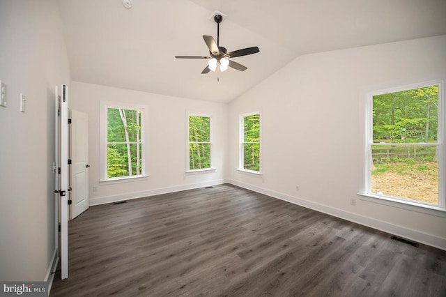  - empty room with lofted ceiling, plenty of natural light, ceiling fan, and dark wood-style floors