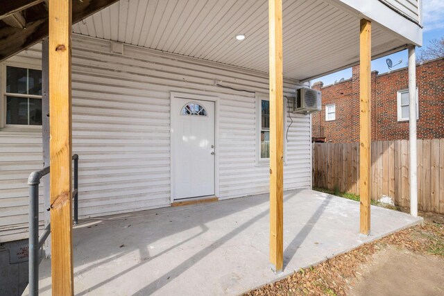 view of patio featuring a wall mounted air conditioner