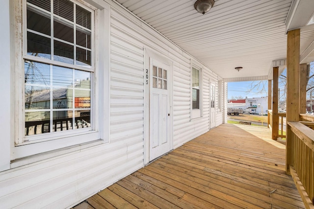 wooden terrace featuring covered porch