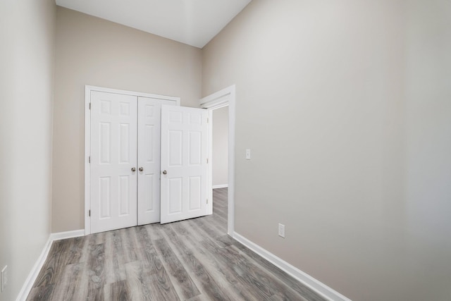 unfurnished bedroom with light hardwood / wood-style floors and a closet