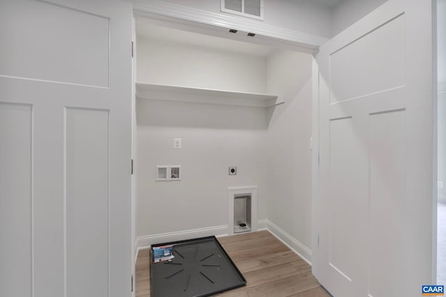washroom with hookup for a washing machine, light wood finished floors, visible vents, hookup for an electric dryer, and laundry area