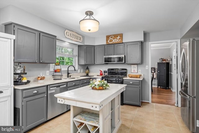 4924 Queensbury Cir, Fredericksburg, VA 22408 - kitchen with stainless steel appliances, gray cabinets, light countertops, open shelves, and light tile patterned floors