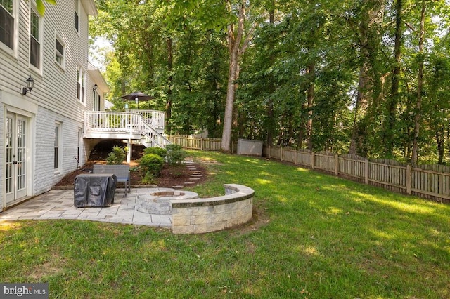 4924 Queensbury Cir, Fredericksburg, VA 22408 - fenced backyard with a patio area, a fire pit, stairs, a wooden deck, and french doors