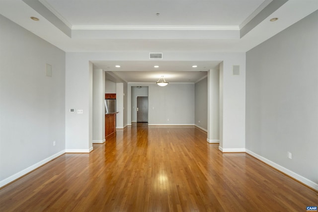 112 5th St SE Unit 3D, Charlottesville, VA 22902 - empty room featuring wood finished floors, recessed lighting, ornamental molding, and a tray ceiling