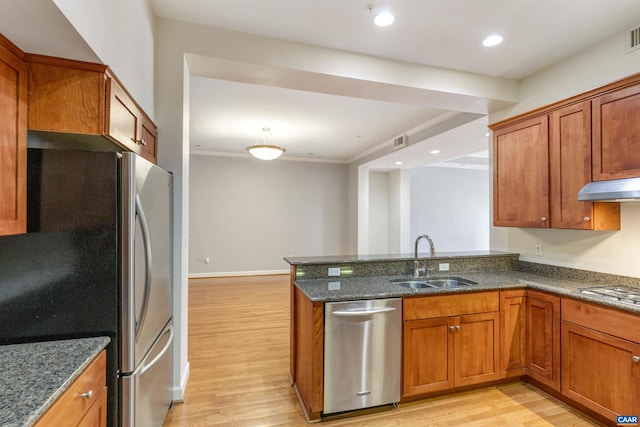 112 5th St SE Unit 3D, Charlottesville, VA 22902 - kitchen with stainless steel appliances, light wood-type flooring, brown cabinets, dark stone countertops, and crown molding