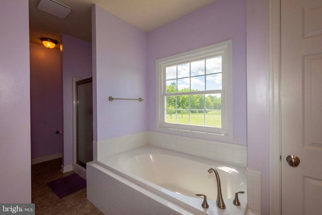 7204 Morris Rd, Spotsylvania, VA 22551 - bathroom featuring a stall shower, a garden tub, and baseboards
