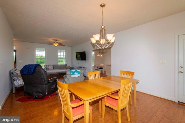 7204 Morris Rd, Spotsylvania, VA 22551 - dining space featuring light wood-type flooring, a chandelier, a ceiling fan, and baseboards