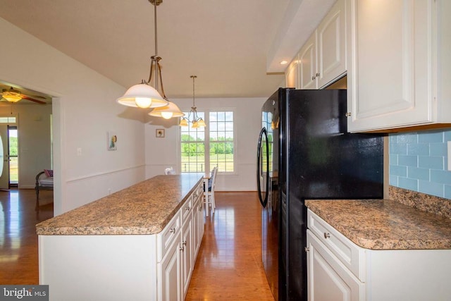 7204 Morris Rd, Spotsylvania, VA 22551 - kitchen featuring wood finished floors, freestanding refrigerator, a kitchen island, and white cabinetry