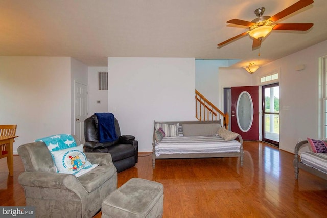 7204 Morris Rd, Spotsylvania, VA 22551 - living area with wood finished floors, a ceiling fan, and stairway