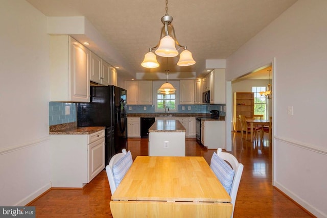 7204 Morris Rd, Spotsylvania, VA 22551 - kitchen featuring a sink, black appliances, a kitchen island, decorative backsplash, and white cabinetry