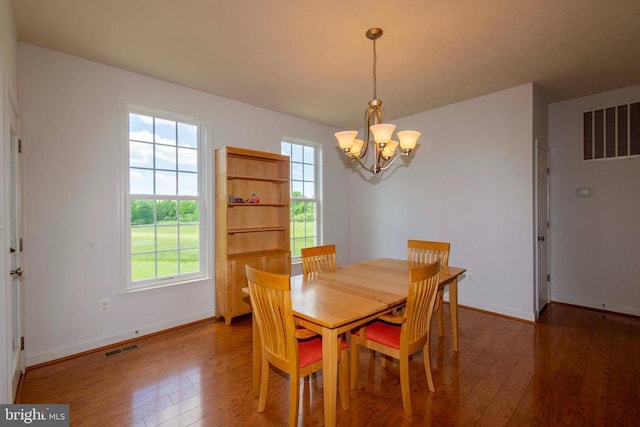 7204 Morris Rd, Spotsylvania, VA 22551 - dining room featuring a chandelier, hardwood / wood-style floors, and baseboards