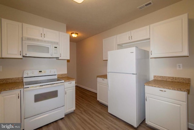 7204 Morris Rd, Spotsylvania, VA 22551 - kitchen featuring white appliances, wood finished floors, white cabinets, baseboards, and light countertops