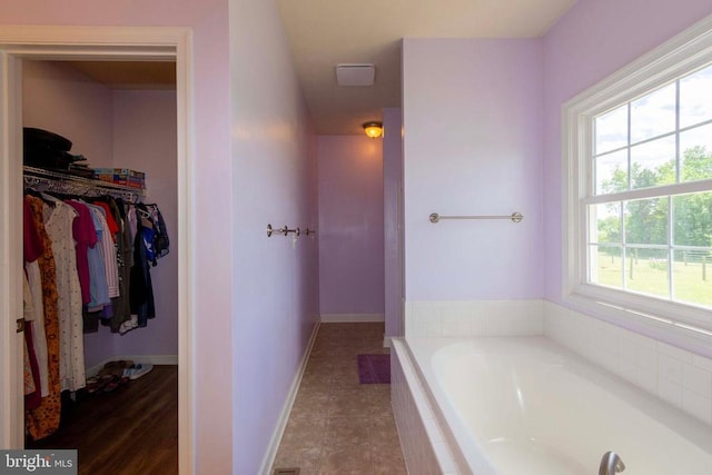 7204 Morris Rd, Spotsylvania, VA 22551 - full bathroom featuring a bath, a spacious closet, and baseboards