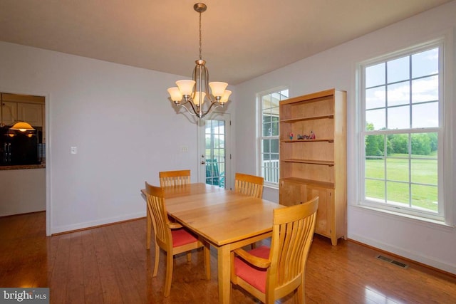 7204 Morris Rd, Spotsylvania, VA 22551 - dining area featuring a chandelier, wood finished floors, and baseboards