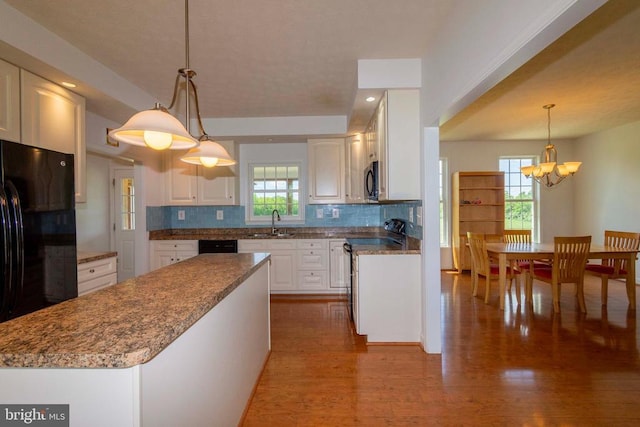 7204 Morris Rd, Spotsylvania, VA 22551 - kitchen with range with electric stovetop, a sink, white cabinets, tasteful backsplash, and freestanding refrigerator
