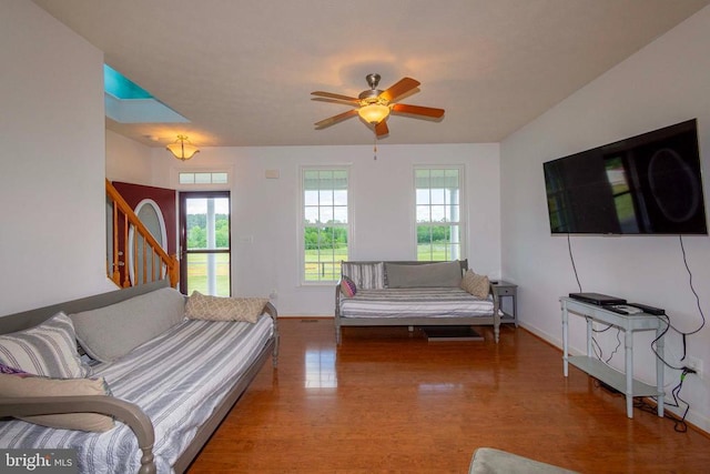 7204 Morris Rd, Spotsylvania, VA 22551 - living area with wood finished floors, stairway, a ceiling fan, and baseboards