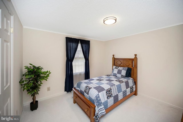 bedroom with light colored carpet, baseboards, ornamental molding, and a textured ceiling