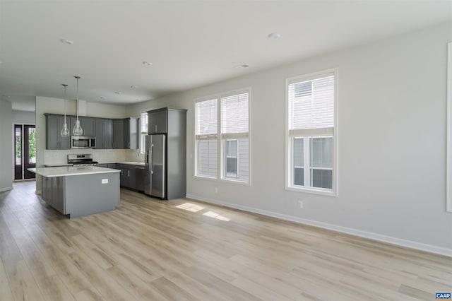 4752 Loyola Way, Charlottesville, VA 22902 - kitchen with appliances with stainless steel finishes, light wood-style floors, light countertops, a center island, and hanging light fixtures