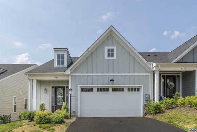 4752 Loyola Way, Charlottesville, VA 22902 - view of front of property featuring board and batten siding, an attached garage, asphalt driveway, and a shingled roof