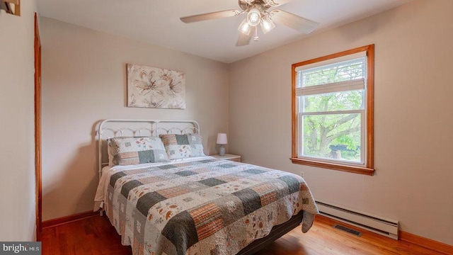 909 Mill Creek Rd, Luray, VA 22835 - bedroom with baseboards, a baseboard radiator, visible vents, and wood finished floors