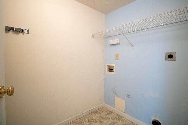clothes washing area featuring washer hookup, electric dryer hookup, and baseboards