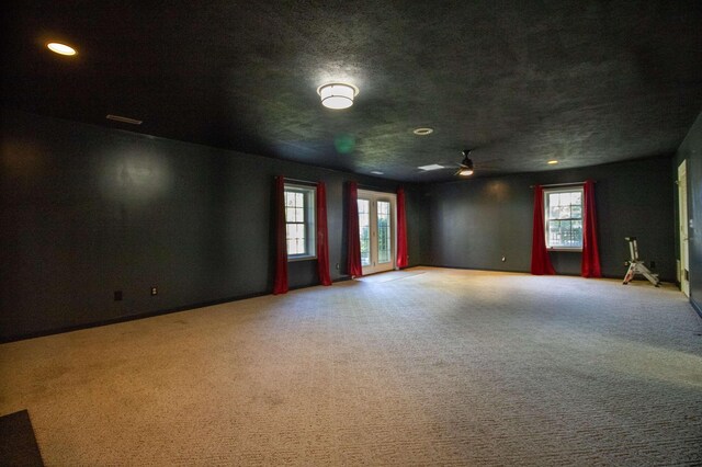 empty room featuring light colored carpet and ceiling fan