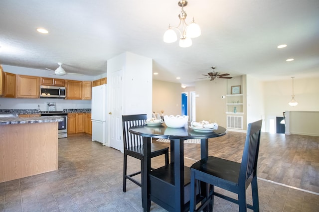 dining area with ceiling fan, a chandelier, recessed lighting, and baseboards