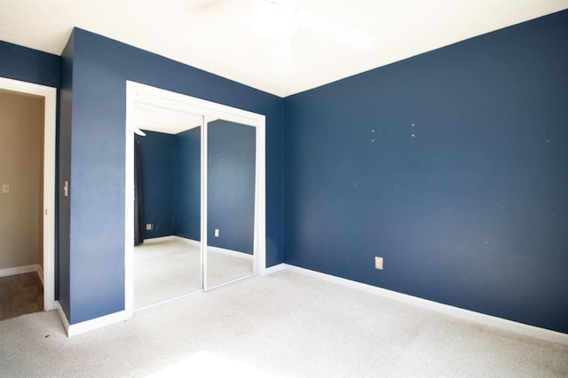 unfurnished bedroom with carpet flooring, baseboards, and a closet
