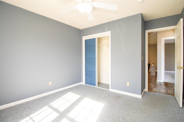 unfurnished bedroom with carpet, a closet, baseboards, and a ceiling fan