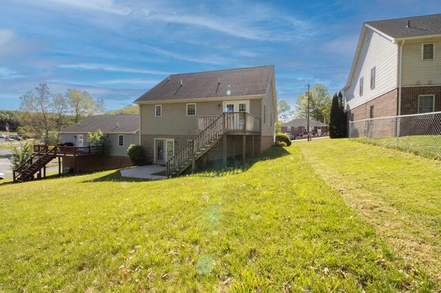 back of house featuring stairs and a wooden deck