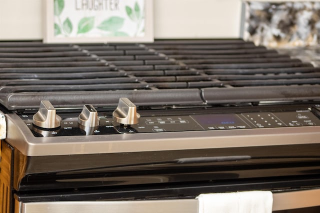 kitchen view of decorative backsplash and stainless steel gas range oven