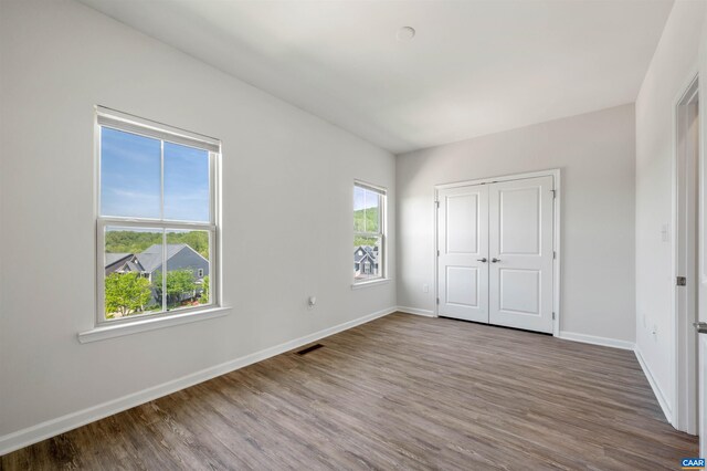 915 Flat Waters Ln, Charlottesville, VA 22911 - unfurnished bedroom with wood finished floors, baseboards, and a closet