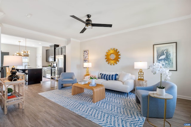 915 Flat Waters Ln, Charlottesville, VA 22911 - living area with ornamental molding, wood finished floors, a ceiling fan, a chandelier, and baseboards