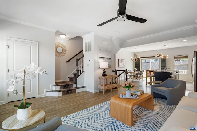 915 Flat Waters Ln, Charlottesville, VA 22911 - living room featuring a chandelier, wood finished floors, ornamental molding, stairs, and a ceiling fan