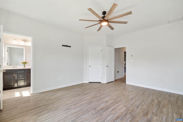 915 Flat Waters Ln, Charlottesville, VA 22911 - unfurnished bedroom with light wood-style floors, baseboards, ensuite bathroom, a sink, and ceiling fan