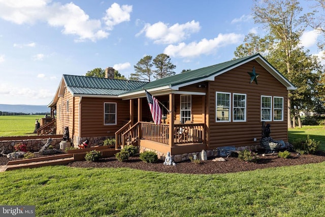 528 Ellis Dr, Luray, VA 22835 - view of front facade featuring log veneer siding, covered porch, metal roof, a front lawn, and a chimney