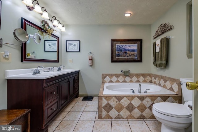 528 Ellis Dr, Luray, VA 22835 - full bathroom with tile patterned floors, toilet, a bath, a textured ceiling, and double vanity