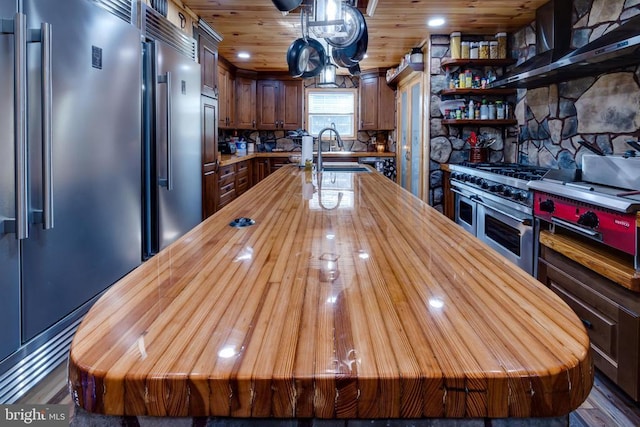 528 Ellis Dr, Luray, VA 22835 - kitchen with butcher block counters, built in refrigerator, extractor fan, a kitchen island, and a sink