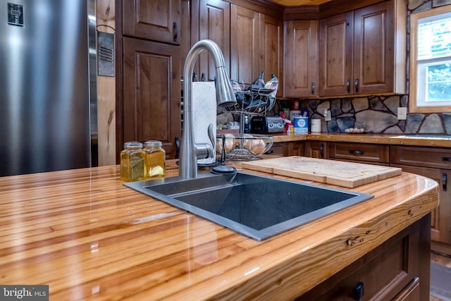 528 Ellis Dr, Luray, VA 22835 - kitchen with freestanding refrigerator, butcher block counters, a sink, and tasteful backsplash