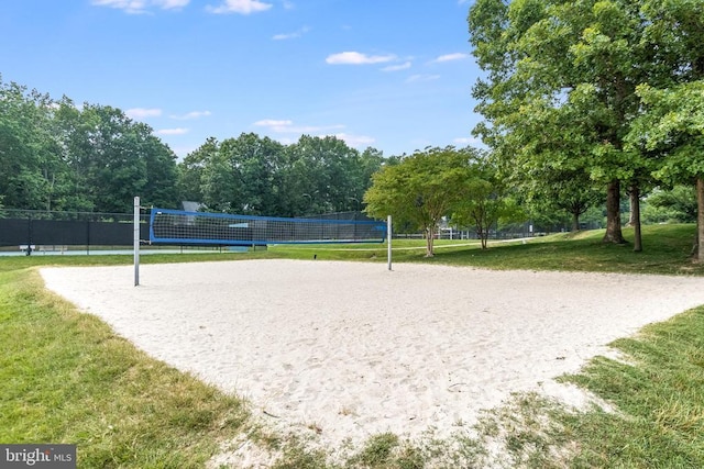 surrounding community featuring a lawn and volleyball court