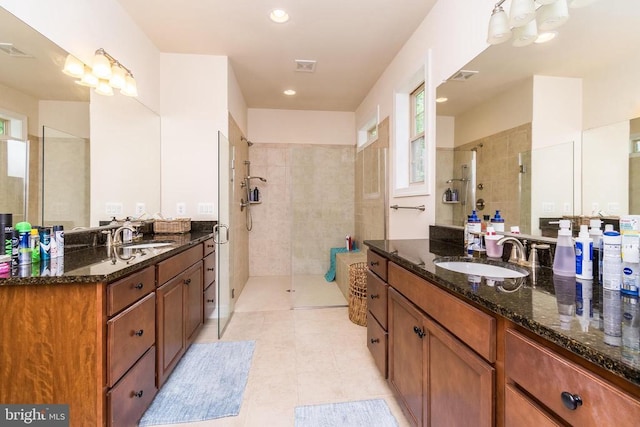 bathroom featuring vanity, tile patterned floors, and walk in shower