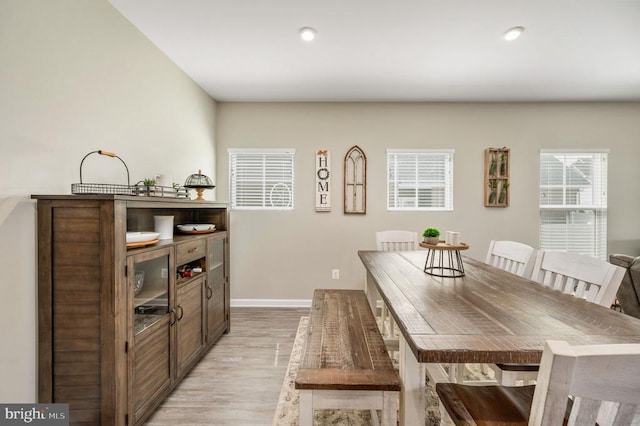 dining space with light wood-style flooring, baseboards, and recessed lighting