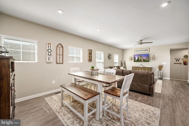 dining space featuring a ceiling fan, baseboards, wood finished floors, and recessed lighting